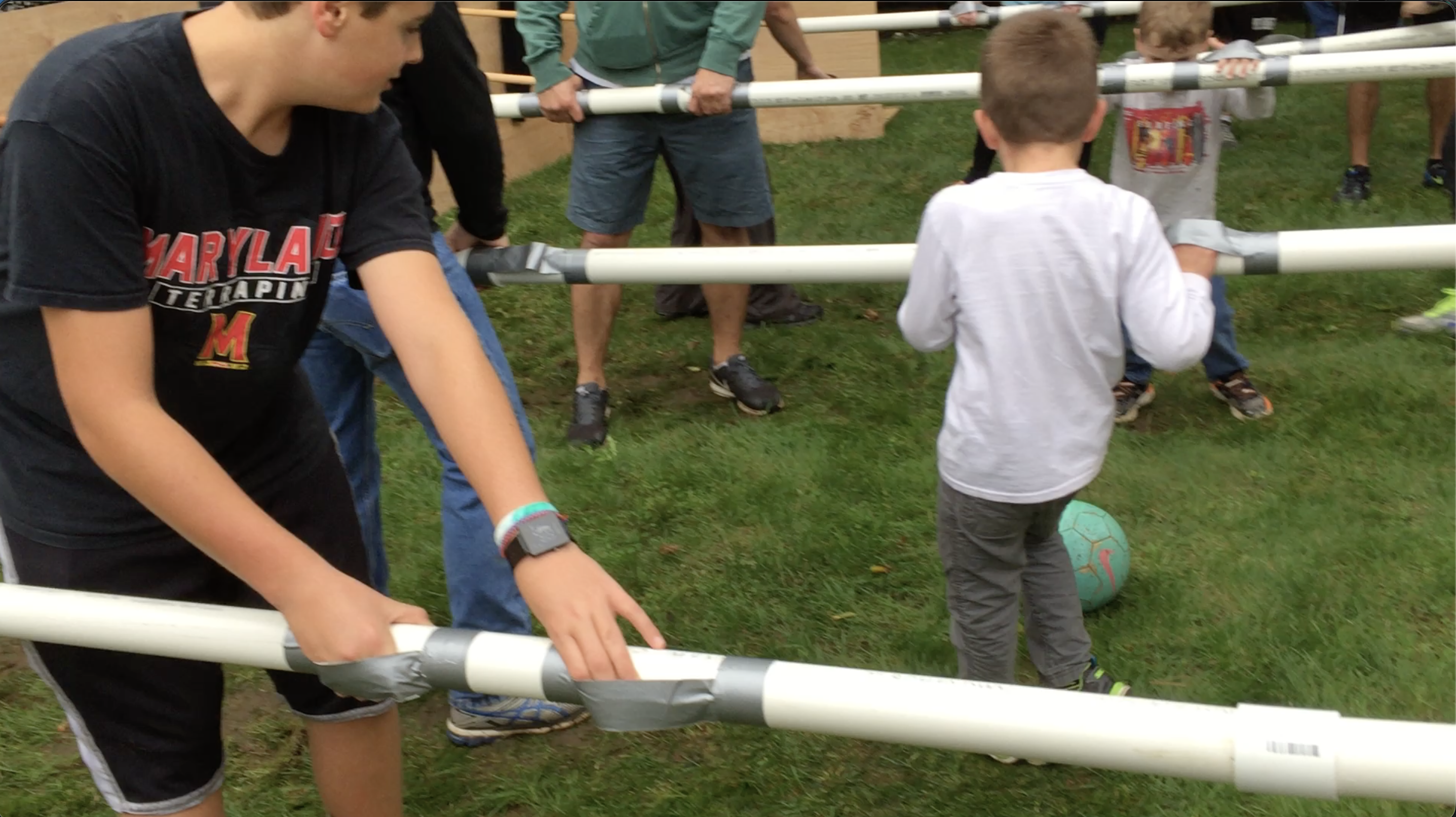 Family playing Human Foosball